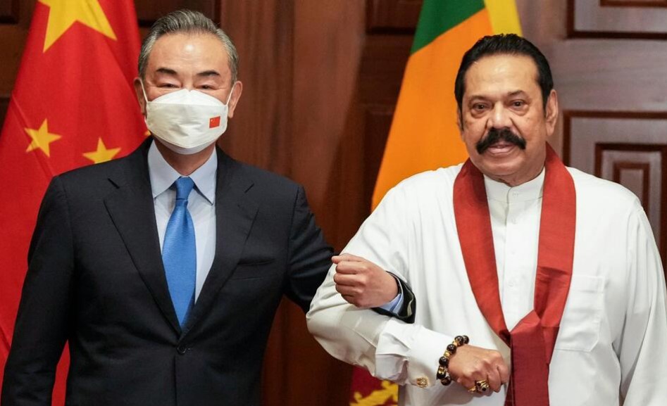 Chinese Foreign Minister Wang Yi, left,  Sri Lankan Prime Minister Mahinda Rajapaksa