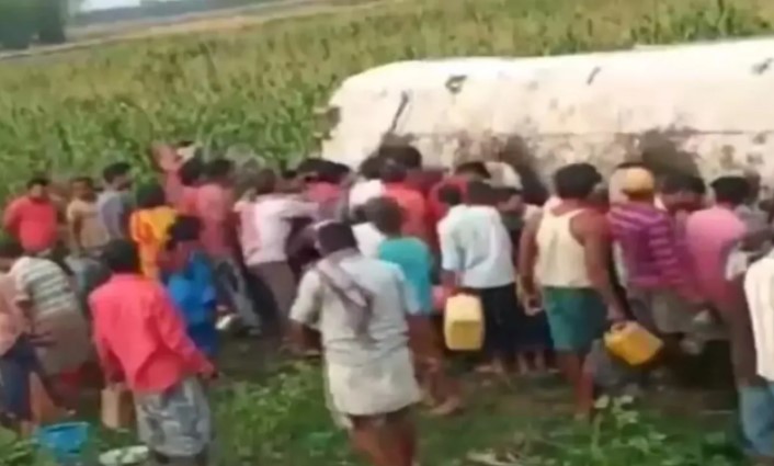 People rushed with buckets and containers after the petrol tanker overturned