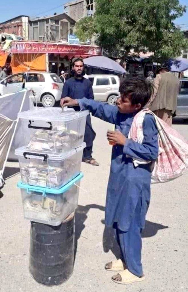 A photo showcasing humanity and brotherhood. A street worker child donating In Nangarhar to the people affected by the recent earthquake in eastern Afghanistan